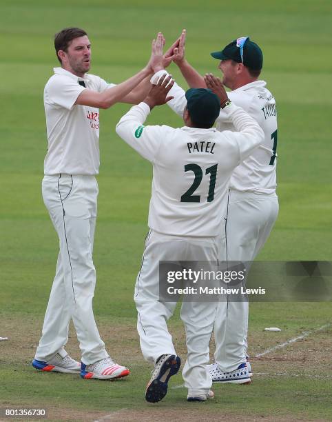 Harry Gurney of Nottinghamshire is congratulated on bowling Will Gidman of Kent during the Specsavers County Championship Division Two match between...