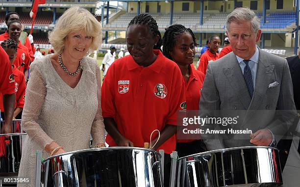 Prince Charles, Prince of Wales and Camilla, Duchess of Cornwall try out some tin pan drums during a visit to Queen's Park Cricket Ground in Trinidad...