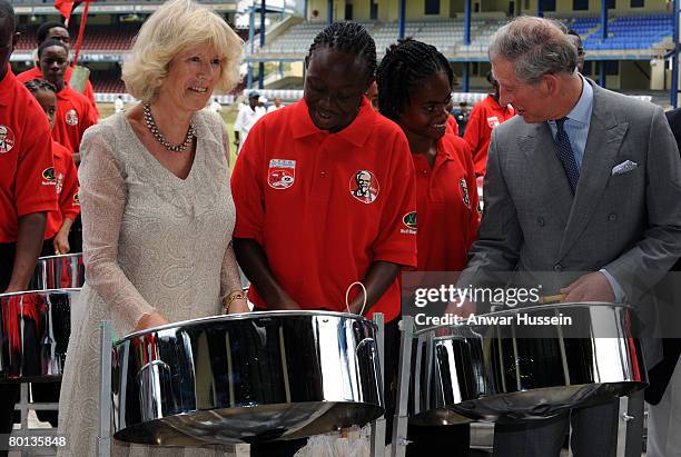 Prince Charles, Prince of Wales and Camilla, Duchess of Cornwall try out some tin pan drums during a visit to Queen's Park Cricket Ground in Trinidad...