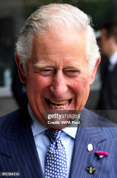 Prince Charles, Prince of Wales wears a brooch in the shape of a Bee which has become a symbol of resilience in the city, after meeting with people...