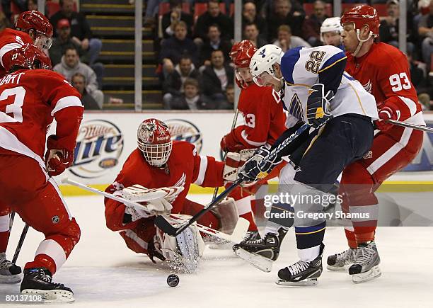 Dominik Hasek of the Detroit Red Wings keeps an eye on the puck behind Brad Boyes of the St. Louis Blues on March 5, 2008 at Joe Louis Arena in...