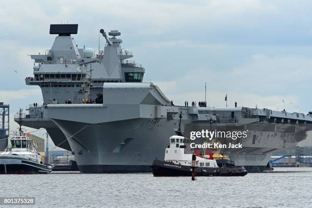 The aircraft carrier HMS Queen Elizabeth leaves Rosyth dockyard to begin sea trials before entering service with the fleet, on June 26, 2017 in...