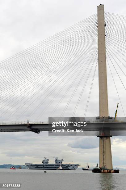 The aircraft carrier HMS Queen Elizabeth, with the new Queensferry Crossing road bridge across the Forth Esturary in the foreground, leaves Rosyth...