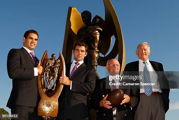 Greg Inglis and Cameron Smith of the Melbourne Storm pose with rugby league legends Authur Summons and Norm Provan and the premiership trophy during...