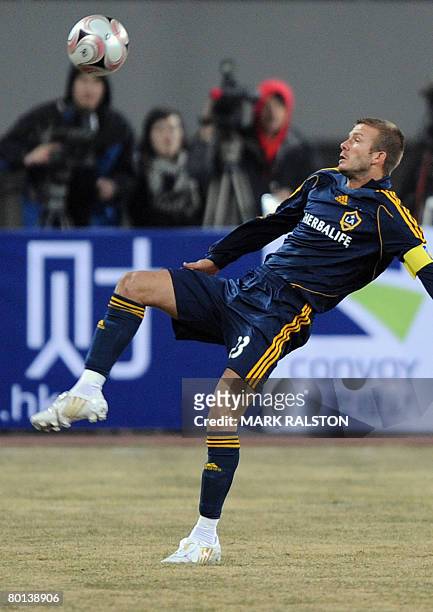 English football star David Beckham from the LA Galaxy team, stretches for a ball during their exhibition match which they won 3-0 against a joint...