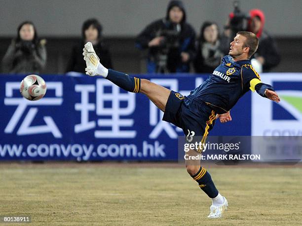 English football star David Beckham from the LA Galaxy team, stretches for a ball during their exhibition match which they won 3-0 against a joint...