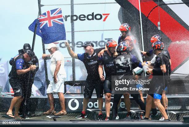 Emirates Team New Zealand helmed by Peter Burling celebrate after winning the America's Cup Match Presented by Louis Vuitton on June 26, 2017 in...