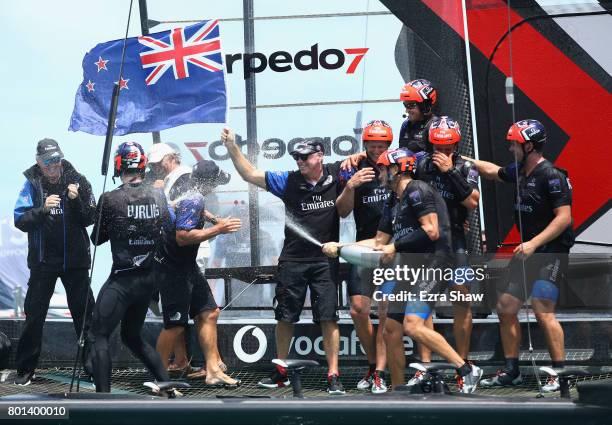Emirates Team New Zealand helmed by Peter Burling celebrate after winning the America's Cup Match Presented by Louis Vuitton on June 26, 2017 in...