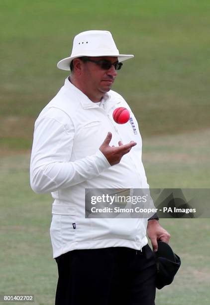 Umpire Neil Bainton holds the pink ball during the Specsavers County Championship, Division Two match at Trent Bridge, Nottingham.