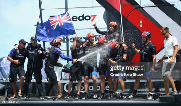 Emirates Team New Zealand helmed by Peter Burling celebrate after winning the America's Cup Match Presented by Louis Vuitton on June 26, 2017 in...