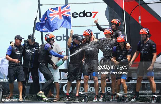 Emirates Team New Zealand helmed by Peter Burling celebrate after winning the America's Cup Match Presented by Louis Vuitton on June 26, 2017 in...