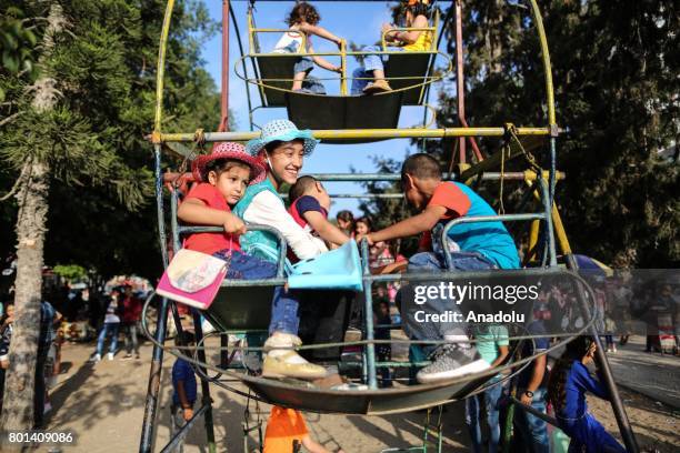 Children enjoy at unknown soldier Park in Gaza during the Eid al-Fitr on July 26, 2017. Muslims around the world are celebrating the Eid al-Fitr...