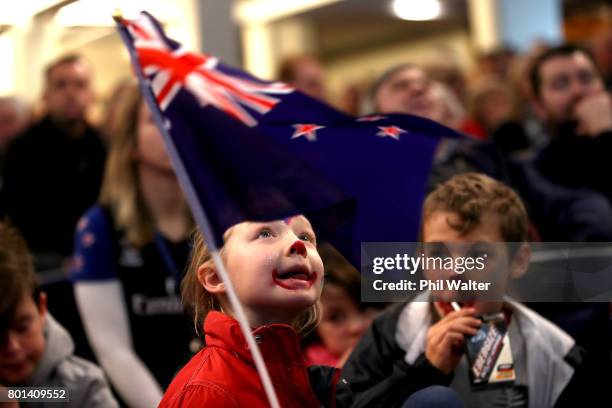 Team New Zealand supporters celebrate as they watch the racing at the Royal New Zealand Yacht Squadron as Team New Zealand win the Americas Cup over...