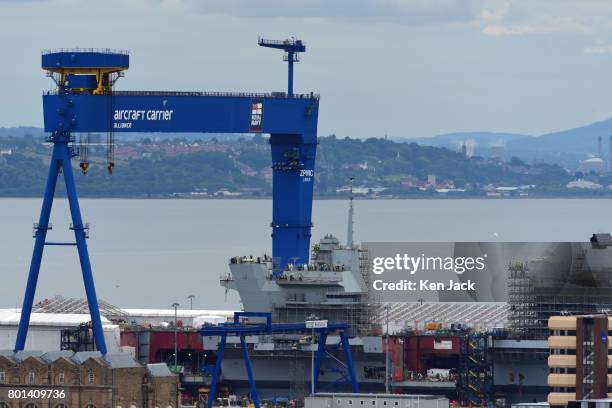 Prince of Wales and the giant crane specially built for the Navy's two giant aircraft carriers pictured at Rosyth Dockyard, on June 26, 2017 in...