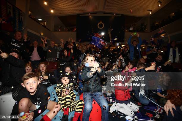 Team New Zealand supporters celebrate as they watch the racing at the Royal New Zealand Yacht Squadron as Team New Zealand win the Americas Cup over...