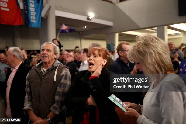 Team New Zealand supporters celebrate as they watch the racing at the Royal New Zealand Yacht Squadron as Team New Zealand win the Americas Cup over...