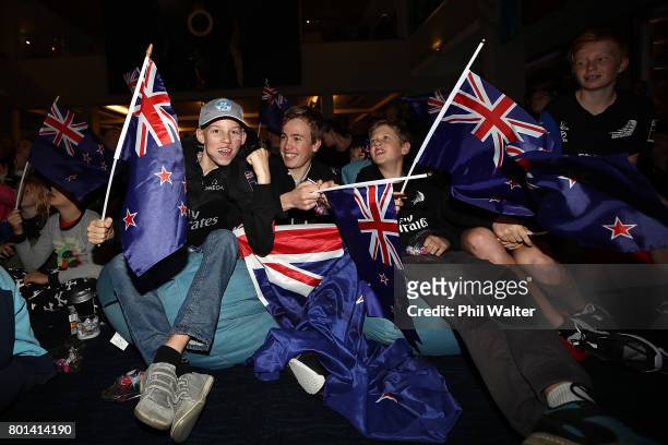 Team New Zealand supporters celebrate as they watch the racing at the Royal New Zealand Yacht Squadron as Team New Zealand win the Americas Cup over...