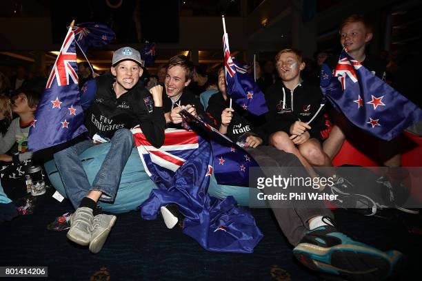 Team New Zealand supporters celebrate as they watch the racing at the Royal New Zealand Yacht Squadron as Team New Zealand win the Americas Cup over...