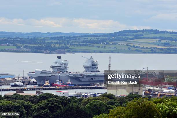 The aircraft carrier HMS Queen Elizabeth leaves Rosyth dockyard to begin sea trials before entering service with the fleet, on June 26, 2017 in...