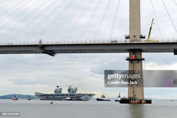 The aircraft carrier HMS Queen Elizabeth, with the new Queensferry Crossing road bridge across the Forth Estuary in the foreground, leaves Rosyth...