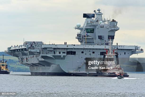 The aircraft carrier HMS Queen Elizabeth leaves Rosyth dockyard to begin sea trials before entering service with the fleet, on June 26, 2017 in...