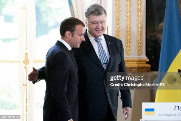 French President Emmanuel Macron receives Ukrainian President Petro Porochenko for a meeting and a press conference at the Elysee Palace on June 26,...