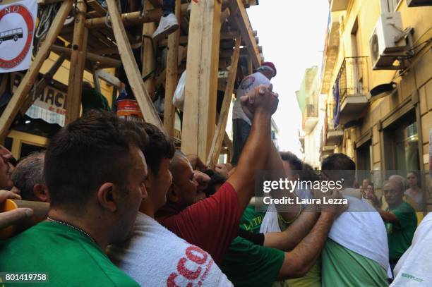Men carry a 25-metre tall wood and papier-mache statue called 'giglio' during the annual Festa dei Gigli on June 26, 2017 in Nola, Italy. When St....