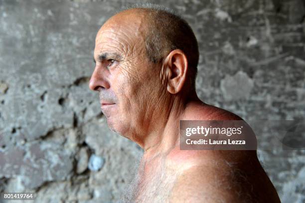 Man poses for a photo just after the annual Festa dei Gigli with his shoulder strain called 'patana' or 'pataniello' caused by having carried a...