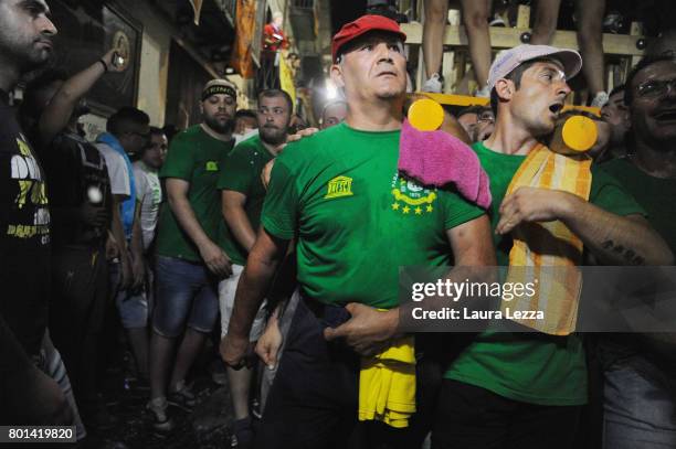 Men carry a 25-metre tall wood and papier-mache statue called 'giglio' during the annual Festa dei Gigli on June 26, 2017 in Nola, Italy. When St....