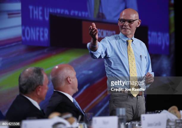 Former New York City Mayor Michael Bloomberg and incoming US Conference of Mayors President Mayor Mitch Landrieu listen as James Carville speaks...