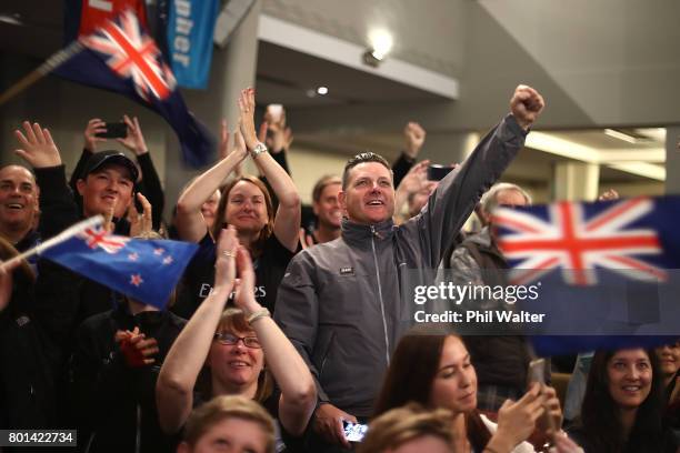 Team New Zealand supporters celebrate as they watch the racing at the Royal New Zealand Yacht Squadron as Team New Zealand win the Americas Cup over...