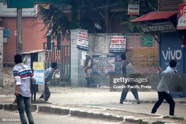 Kashmiri protesters pelting stones to the police officers and paramilitary soldiers after the culmination of 'Eid-ul-Fitr congregational prayer....