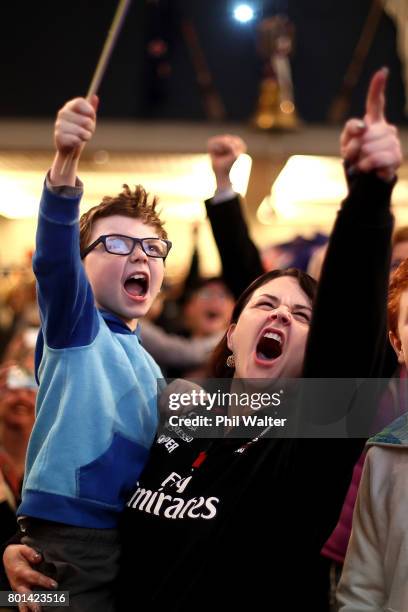 Team New Zealand supporters celebrate as they watch the racing at the Royal New Zealand Yacht Squadron as Team New Zealand win the Americas Cup over...