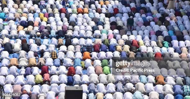 Indian Muslim devotees offer Eid prayers at the start of the Eid al-Fitr, marking the end of Ramadan at the Eid Gah mosque in Guwahati. Muslims...