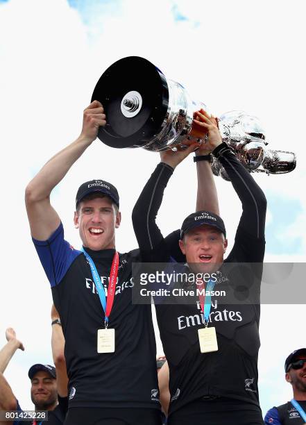 Peter Burling and Glenn Ashby of Emirates Team New Zealandlift the trophy after winning race 9 against Oracle Team USA to win the America's Cup on...