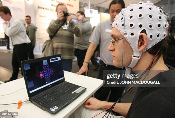 An engineer uses a Brain-Computer Interface to communicate with a computer at the CeBIT trade fair in Hanover on March 6, 2008. The BCI, developed by...