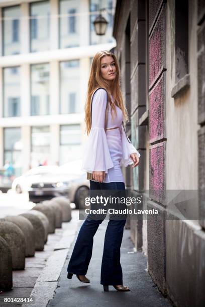 Fasion stylist and blogger Angelina Lepper wears a La Perla white tunica, Max&Co jeans, Asos shoes and a Roberto di Stefano golden bag, on June 26,...