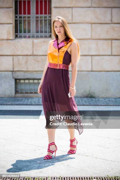 Fasion stylist and blogger Angelina Lepper wears a Mauro Gasperi orange gilet, Oroblu purple dress and Manfredi Manara pink shoes, on June 26, 2017...