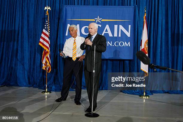 Florida Gov. Charlie Crist listens as Republican presidential nominee U.S. Sen. John McCain speaks to the press at Signature Flight Support March 6,...