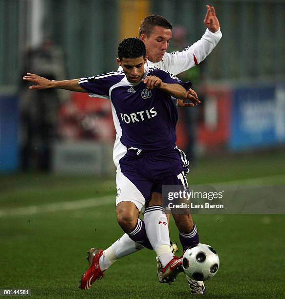 Lukas Podolski of Munich in action with Mbark Boussoufa of Anderlecht during the UEFA Cup Round of 16 first leg match between RSC Anderlecht and...