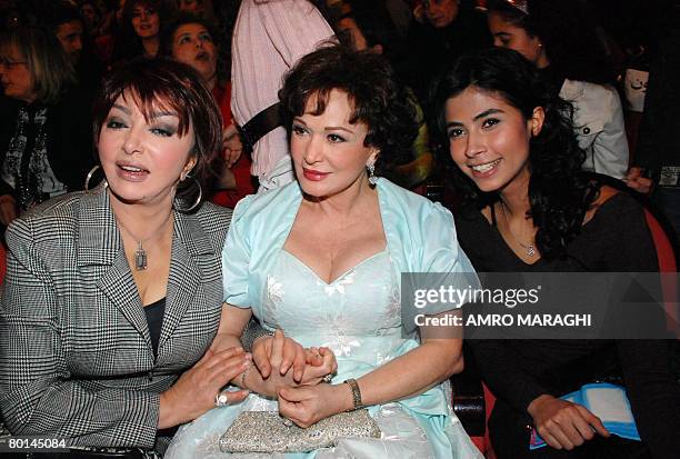 Egyptian pop star Ruby poses for a picture with veteran actresses Nabil Ebeid and Lebleba at the opening ceremony of the Cairo International Children...