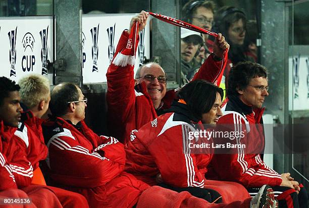 Manager Ulli Hoeness of Munich shows his fanscarve to the Munich fans during the UEFA Cup Round of 16 first leg match between RSC Anderlecht and...
