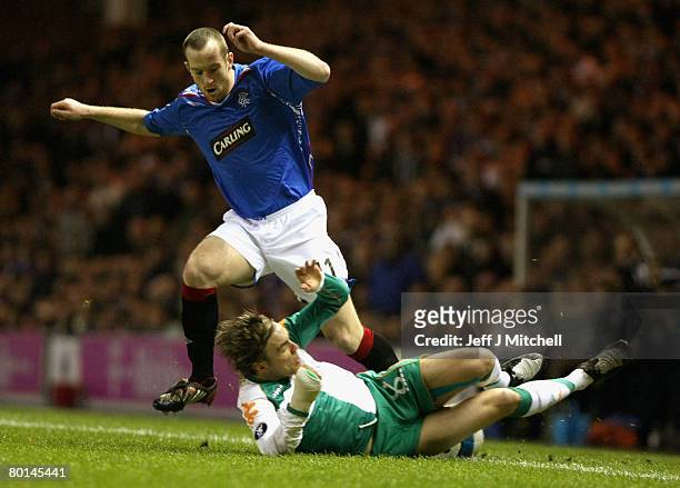 Charlie Adam of Rangers tackles Fritz Clemens of Werder Bremen during the UEFA Cup round of 16, first leg match at Ibrox Stadium March 6, 2008 in...
