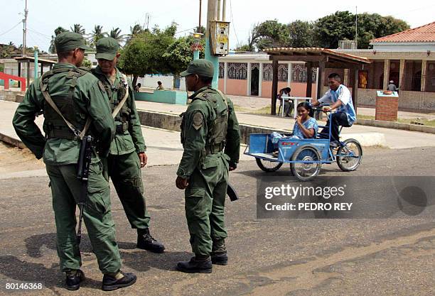 Venezuelan soldiers patrol along one of the main streets of Mojan, in the state of Maracaibo, in the Venezuelan border with Colombia on March 6,...