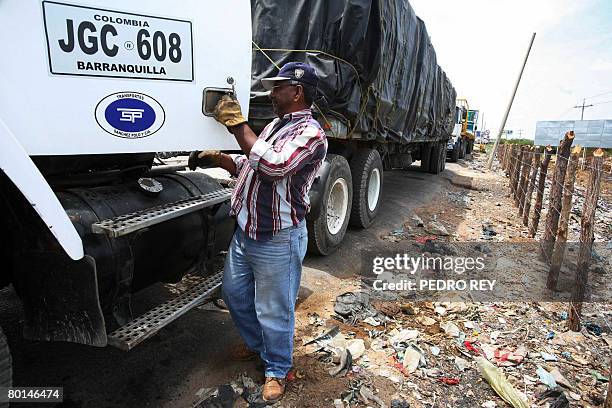 Truck driver climbs into his vehicle at the Venezuelan-Colombian border post, in Paraguachon, in the Venezuelan state of Maracaibo, on March 6, 2008....
