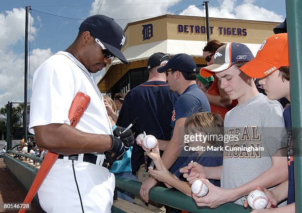 Jacque Jones of the Detroit Tigers signs autographs for fans before the spring training game against Florida Southern College at Joker Marchant...