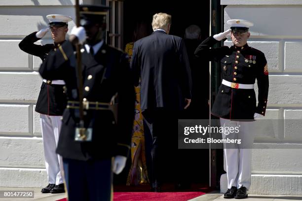 President Donald Trump, center, walks with U.S. First Lady Melania Trump, into the White House after greeting Narendra Modi, India's prime minister,...