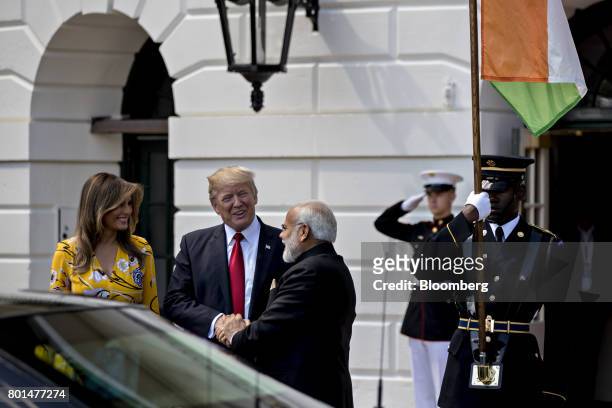 President Donald Trump, center, shakes hands Narendra Modi, India's prime minister, right, with U.S. First Lady Melania Trump, at the South Portico...