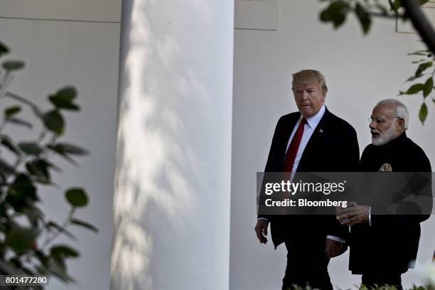 President Donald Trump, left, and Narendra Modi, India's prime minister, walk through the Colonnade of the White House in Washington, D.C., U.S., on...