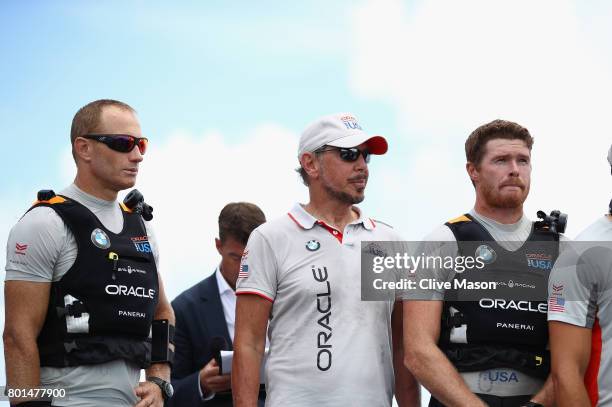 Jimmy Spithill, Larry Ellison and Tom Slingsby of Oracle Team USA look on as Emirates Team New Zealand win race 9 against Oracle Team USA to win the...